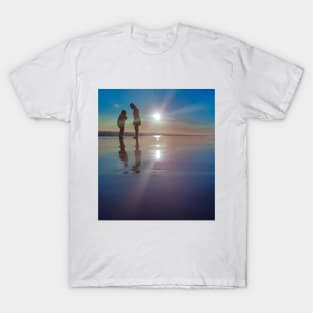 Silhouetted people in a row on a sand beach. T-Shirt